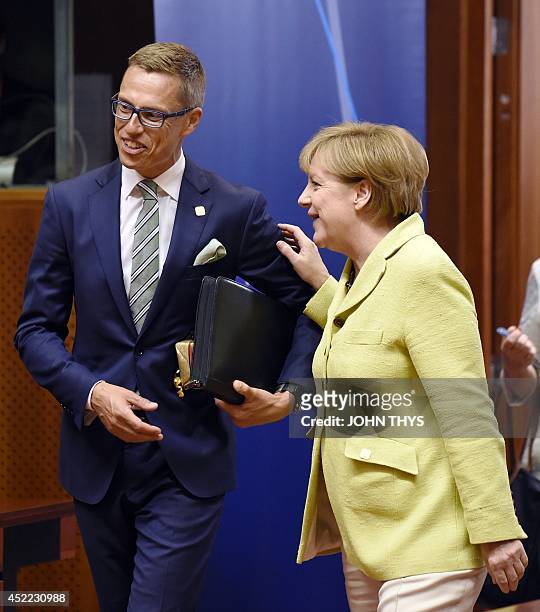 Finnish Prime Minister Alexander Stubb talks with German Chancellor Angela Merkel on July 16, 2014 in Brussels before a special meeting of the...