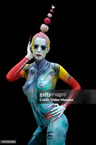 Participant poses with her body paintings designed by bodypainting artist Benoit Steek during the 17th World Bodypainting Festival in Poertschach on...