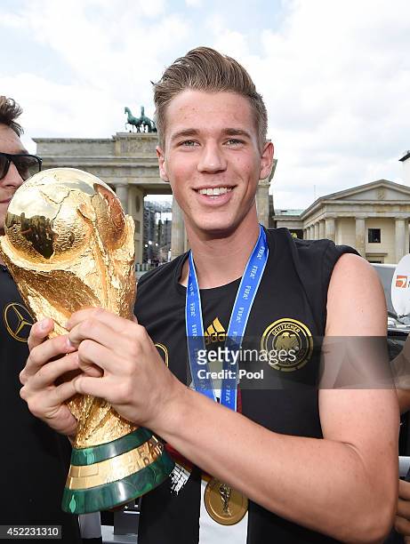 Erik Durm celebrates during the German team victory ceremony on July 15, 2014 in Berlin, Germany. Germany won the 2014 FIFA World Cup Brazil match...