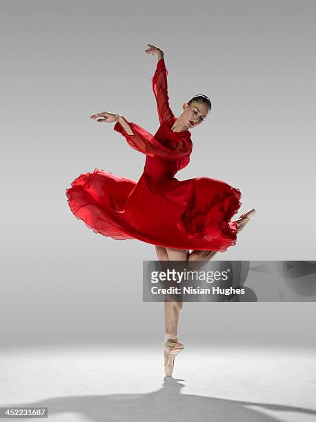 ballerina in contemporary ballet position - red dress stock pictures, royalty-free photos & images