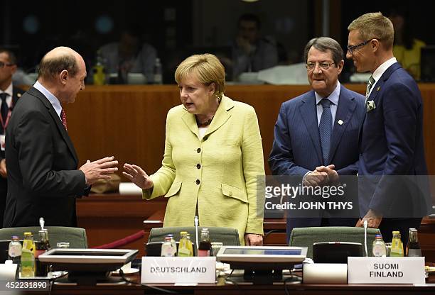 German Chancellor Angela Merkel talks with Roumanian Prime minister Traian Basescu while Portuguese Prime Minister Pedro Passos Coelho and Finnish...