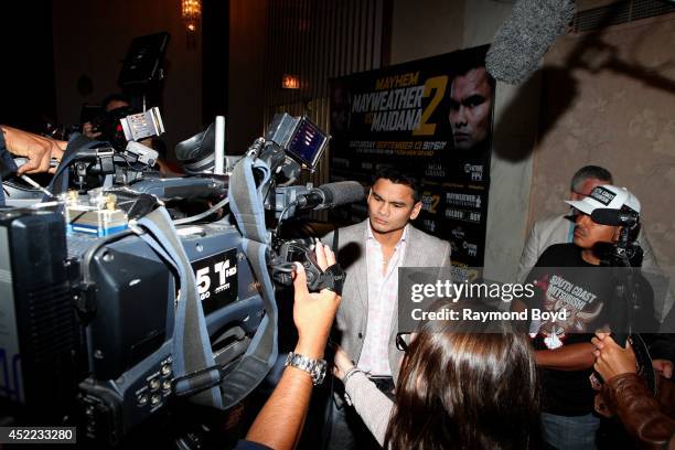 Boxer Marcos "El Chino" Maidana is interviewed during the "Mayhem: Mayweather vs. Maidana II" championship rematch press conference at the Congress...