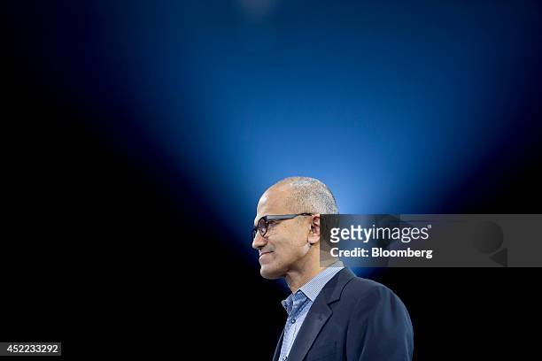 Satya Nadella, chief executive officer of Microsoft Corp., listens to a product demo during a keynote session at the Microsoft Worldwide Partner...