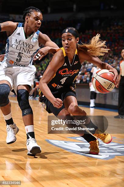 Skylar Diggins of the Tulsa Shock drives against Tan White of the Minnesota Lynx during the WNBA game on July 16, 2014 at Target Center in...