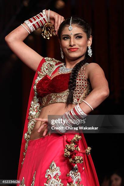 Model walks the runway at the Swarovski show during day 2 of the India International Jewellery Week 2014 at grand Hyatt on July 15, 2014 in Mumbai,...