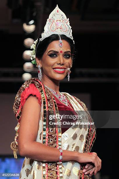 Natasha Suri walks the runway at the Swarovski show during day 2 of the India International Jewellery Week 2014 at grand Hyatt on July 15, 2014 in...