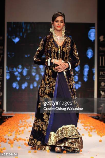 Model walks the runway at the Swarovski show during day 2 of the India International Jewellery Week 2014 at grand Hyatt on July 15, 2014 in Mumbai,...