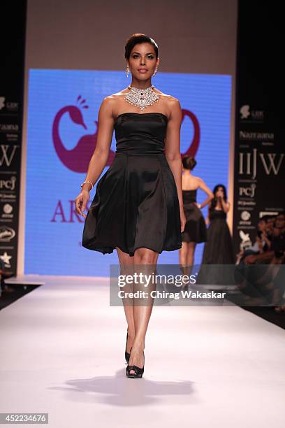 Model walks the runway at the Aks Jewels show during day 2 of the India International Jewellery Week 2014 at grand Hyatt on July 15, 2014 in Mumbai,...