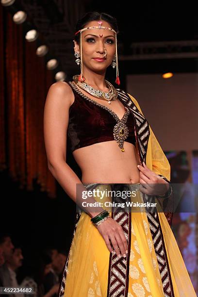 Model walks the runway at the Swarovski show during day 2 of the India International Jewellery Week 2014 at grand Hyatt on July 15, 2014 in Mumbai,...