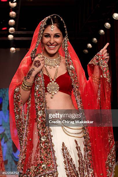 Pooja Chopra walks the runway at the Swarovski show during day 2 of the India International Jewellery Week 2014 at grand Hyatt on July 15, 2014 in...