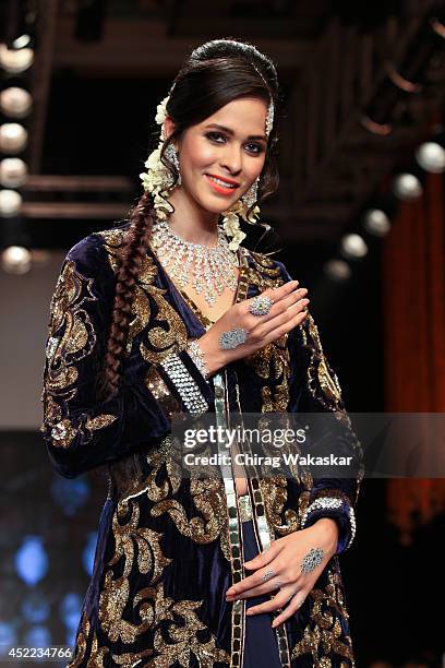 Model walks the runway at the Swarovski show during day 2 of the India International Jewellery Week 2014 at grand Hyatt on July 15, 2014 in Mumbai,...