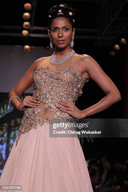 Model walks the runway at the Swarovski show during day 2 of the India International Jewellery Week 2014 at grand Hyatt on July 15, 2014 in Mumbai,...