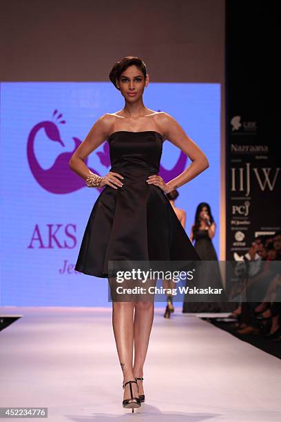 Model walks the runway at the Aks Jewels show during day 2 of the India International Jewellery Week 2014 at grand Hyatt on July 15, 2014 in Mumbai,...