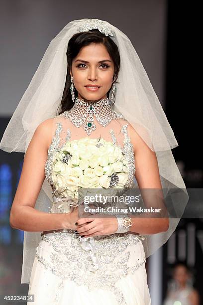 Manasi Moghe walks the runway at the Swarovski show during day 2 of the India International Jewellery Week 2014 at grand Hyatt on July 15, 2014 in...