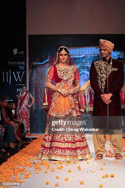 Model walks the runway at the Zarine Khan show during day 2 of the India International Jewellery Week 2014 at grand Hyatt on July 15, 2014 in Mumbai,...