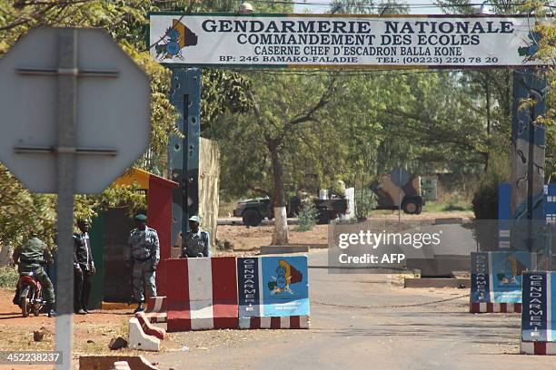 Malian security forces stand guard outside the gendarmerie where Malian ex-coup leader Amadou Sanogo was brought to after being detained in Bamako on...