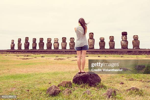 woman taking a picture of the fifteen moai - moai statue stock pictures, royalty-free photos & images