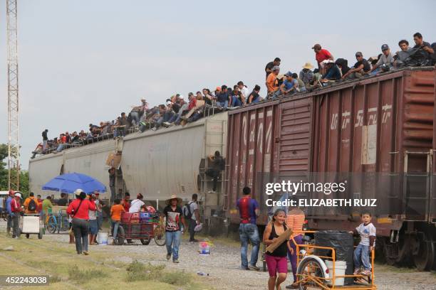 Central American immigrant get on the so-called La Bestia cargo train, in an attempt to reach the Mexico-US border, in Arriaga, Chiapas state, Mexico...