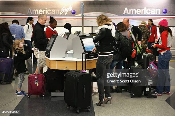 Travelers check in for flights at O'Hare International Airport on November 27, 2013 in Chicago, Illinois. Nearly 1.5 million travelers are expected...