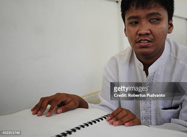 Visually impaired student reads a Braille Quran at The Foundation for The Education of Blind Children on July 17, 2014 in Surabaya, Indonesia....