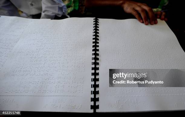 Visually impaired student reads a Braille Quran at The Foundation for The Education of Blind Children on July 17, 2014 in Surabaya, Indonesia....