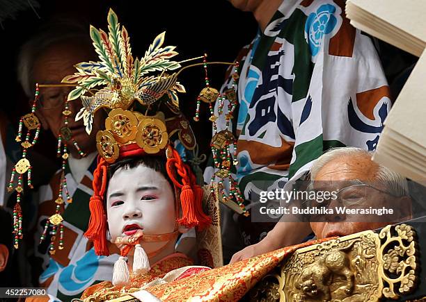 Sacred child sits on a float named Yamahoko during the annual Kyoto Gion Festival on July 17, 2014 in Kyoto, Japan. The Gion festival is one of three...