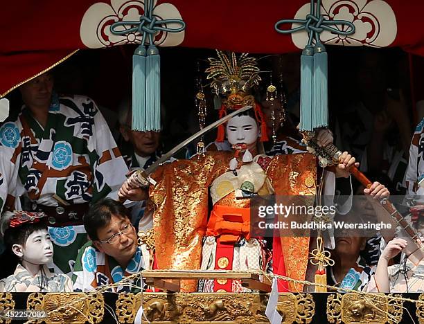 Sacred child performs a ritual on a float named Yamahoko before the cuts a Shimenawa, sacred wire rope during the annual Kyoto Gion Festival on July...