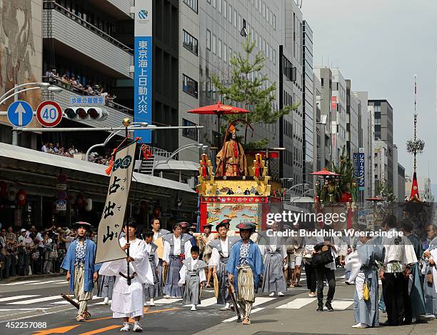 Japanese men dressed in traditional costumes tow a festival carts during the annual Kyoto Gion Festival on July 17, 2014 in Kyoto, Japan. The Gion...