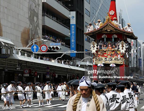 Japanese men dressed in traditional costumes tow a festival cart named Yamahoko during the annual Kyoto Gion Festival on July 17, 2014 in Kyoto,...