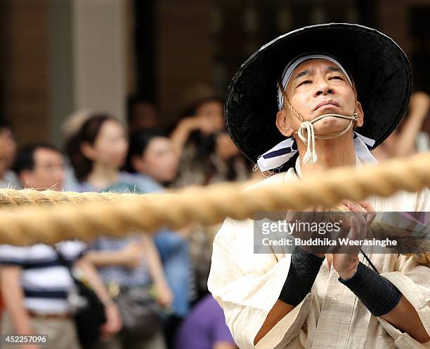 Japanese mea dressed in traditional costumes prepared to tow a festival cart named Yamahoko during the annual Kyoto Gion Festival on July 17, 2014 in...