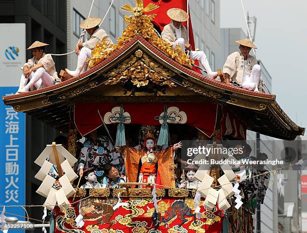 Sacred child performs a ritual on a float named Yamahoko before the cuts a Shimenawa, sacred wire rope during the annual Kyoto Gion Festival on July...