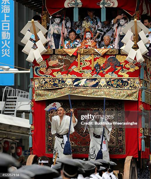 Sacred child sits on a float named Yamahoko as others perform ritual during the annual Kyoto Gion Festival on July 17, 2014 in Kyoto, Japan. The Gion...