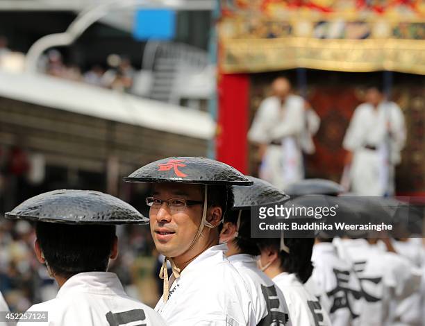 Japanese men dressed in traditional costumes prepared to tow a festival cart named Yamahoko during the annual Kyoto Gion Festival on July 17, 2014 in...