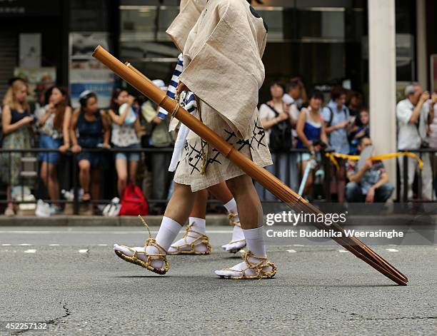 Japanese men dressed in traditional costumes walk in the street during the annual Kyoto Gion Festival on July 17, 2014 in Kyoto, Japan. The Gion...