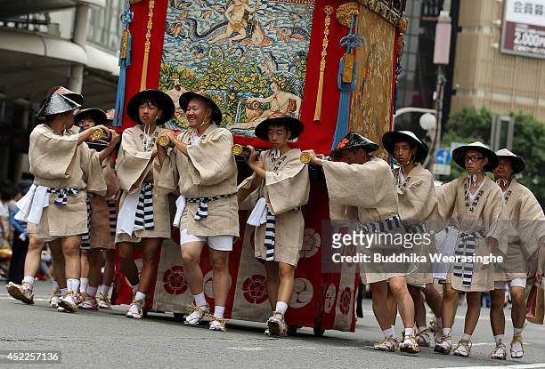 Japanese men dressed in traditional costumes tow a festival cart during the annual Kyoto Gion Festival on July 17, 2014 in Kyoto, Japan. The Gion...