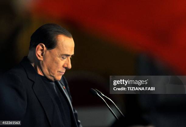 Italy's former Prime Minister Silvio Berlusconi delivers a speech outside his private residence, the Palazzo Grazioli, after his expulsion from the...
