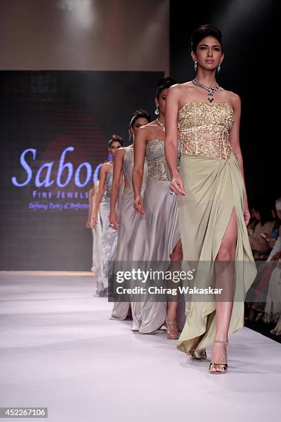 Model walks the runway at the Saboo show during day three of the India International Jewellery Week 2014 at Grand Hyatt on July 16, 2014 in Mumbai,...