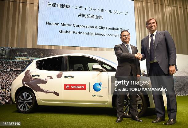 Ferran Soriano , CEO of City Football Group, which owns Manchester City Football Club, shakes hands with Carlos Ghosn , CEO and president of Nissan...