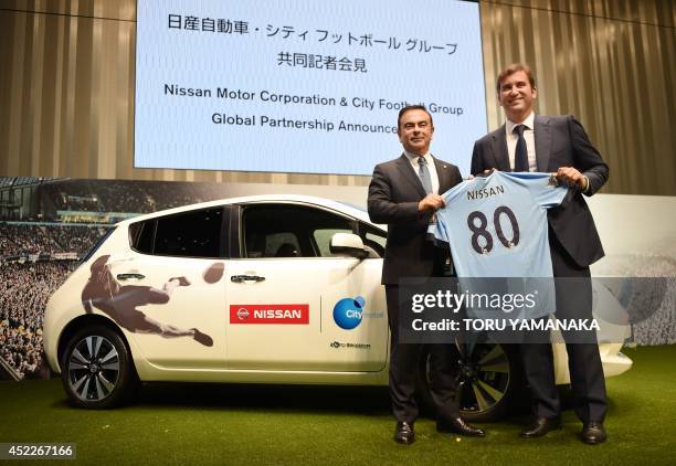 Ferran Soriano , CEO of City Football Group, which owns Manchester City Football Club, gives a Manchester City shirt to Carlos Ghosn , CEO and...