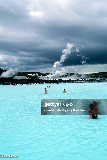 Iceland,near Reykjavik,blue Lagoon Thermal Area, Spa,people In Pool,power Station In Background.