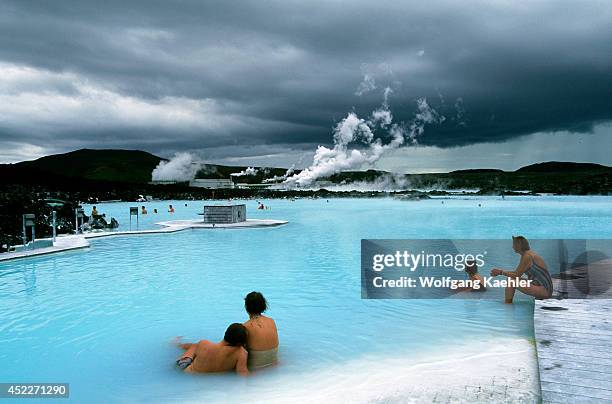 Iceland,near Reykjavik,blue Lagoon Thermal Area, Spa,people In Pool,power Station In Background.