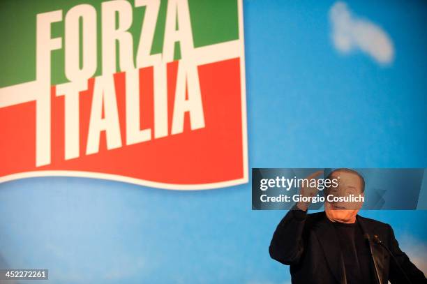 Former Italian Prime Minister Silvio Berlusconi gestures as he attends a rally outside his house, Palazzo Grazioli, on November 27, 2013 in Rome,...