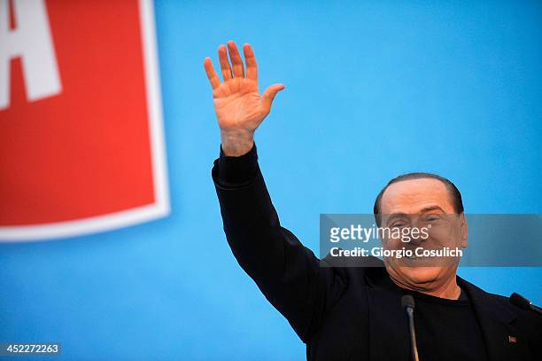 Former Italian Prime Minister Silvio Berlusconi gestures as he attends a rally outside his house, Palazzo Grazioli, on November 27, 2013 in Rome,...