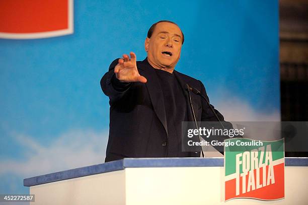 Former Italian Prime Minister Silvio Berlusconi gestures as he attends a rally outside his house, Palazzo Grazioli, on November 27, 2013 in Rome,...