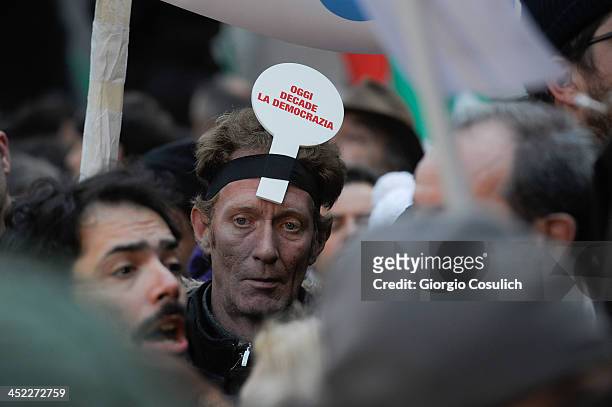 Demonstrator holds a sign reading 'today falls the democracy' during a rally in support of former Italian Prime Minister Silvio Berlusconi in front...