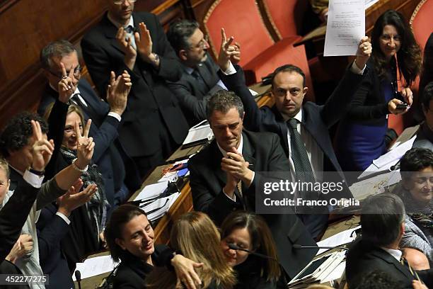 Five Stars Movement senators applaud during the votes over Silvio Berlusconi's Parliament expulsion at the Italian Senate, Palazzo Madama on November...