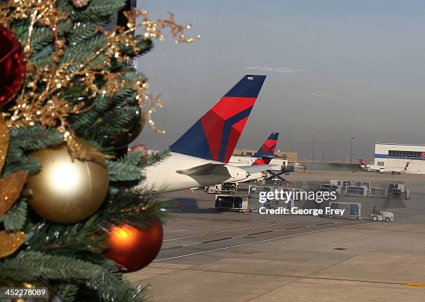 Baggage handlers load and unload Delta planes at the Salt Lake City international Airport on November 27, 2013 in Salt Lake City, Utah. A wintry...