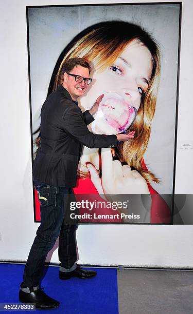 Florian Simbeck poses during the photography exhibition "Bitte recht freundlich" of artist Niels Ruf on November 27, 2013 in Munich, Germany.