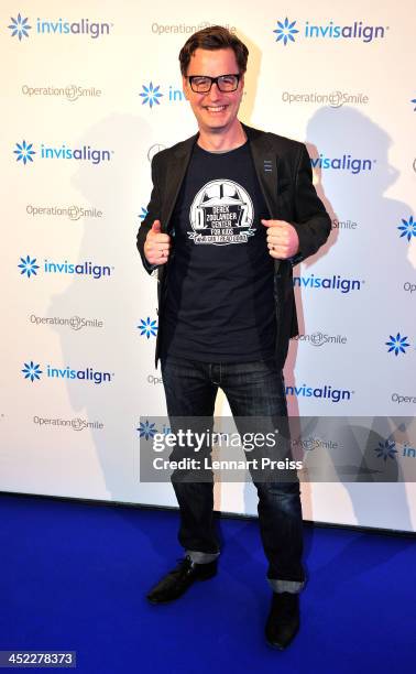 Florian Simbeck poses during the photography exhibition "Bitte recht freundlich" of artist Niels Ruf on November 27, 2013 in Munich, Germany.