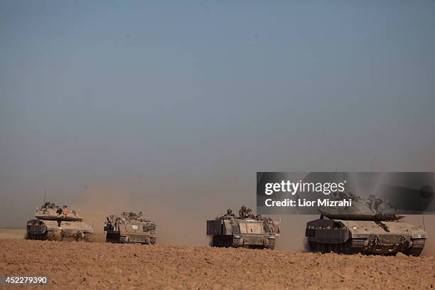 Israeli tanks and Army Armoured Personnel Carrier seen moving along the border with Gaza on July 17, 2014 on Israel's border with the Gaza Strip. As...